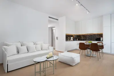 a living room with a white couch and a table at The 12th City Hotel in Rhodes Town