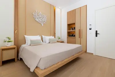 a bedroom with a large white bed with two pillows at The 12th City Hotel in Rhodes Town