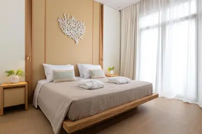 a bedroom with a large bed with two pillows on it at The 12th City Hotel in Rhodes Town