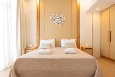 a bedroom with a large bed with two white pillows at The 12th City Hotel in Rhodes Town