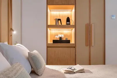 a bedroom with a bed and a book shelf at The 12th City Hotel in Rhodes Town