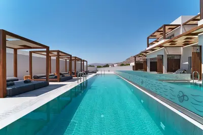 a swimming pool with blue water in a resort at THERETRA PEFKI Seaside in Pefki Rhodes