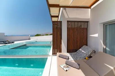 a view of a swimming pool from the balcony of a house at THERETRA PEFKI Seaside in Pefki Rhodes