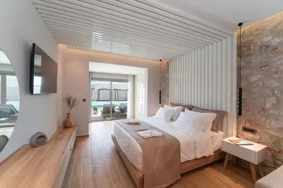a bedroom with a large bed in a room at THERETRA PEFKI Seaside in Pefki Rhodes