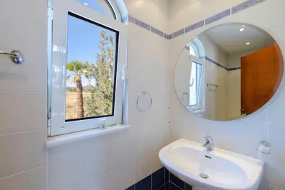 a bathroom with a sink and a mirror at Beachfront Studio Socrates in Gennadi