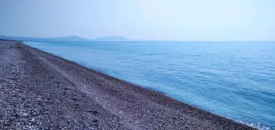 a rocky beach next to a large body of water at Beachfront Studio Socrates in Gennadi