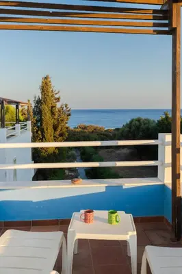 a balcony with a view of the ocean at Beachfront Studio Socrates in Gennadi