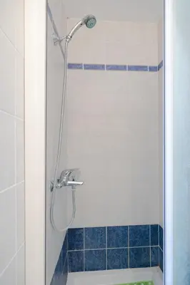 a shower in a bathroom with blue tile at Beachfront Studio Socrates in Gennadi