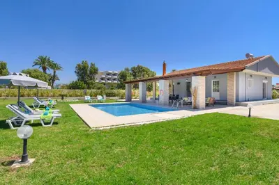 a villa with a swimming pool and a yard at Villa Kalathos by Villa Plus in Kalathos