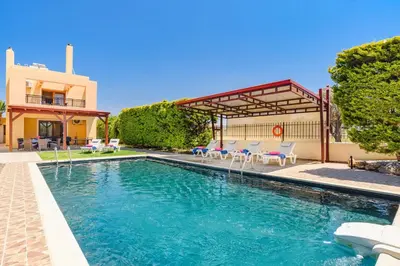 a swimming pool in front of a house at Villa Harmony Rhodes by Villa Plus in Koskinou