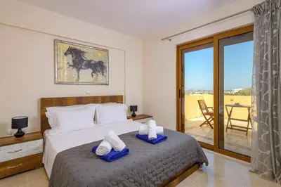 a bedroom with a bed with two towels at Villa Harmony Rhodes by Villa Plus in Koskinou