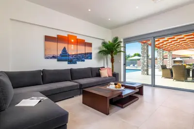 a living room with a couch and a table at Villa Elite Kalathos by Villa Plus in Kalathos