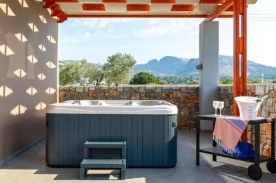 a bath tub on a patio with a view at Villa Elite Kalathos by Villa Plus in Kalathos