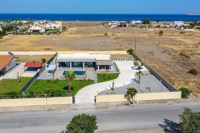 an aerial view of a building with the ocean in the background at Villa Elite Kalathos by Villa Plus in Kalathos