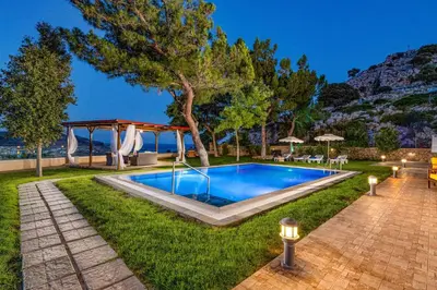 a swimming pool in the middle of a yard at Villa St Nicholas by Villa Plus in Pefki Rhodes