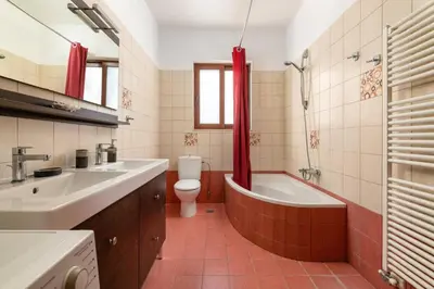 a bathroom with a tub and a toilet and a sink at Villa St Nicholas by Villa Plus in Pefki Rhodes