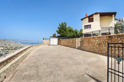 a stone wall with a gate and a building at Villa St Nicholas by Villa Plus in Pefki Rhodes