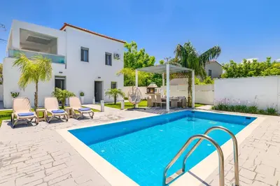 a villa with a swimming pool and a house at Villa Costa by Villa Plus in Ialyssos