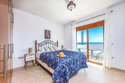 a bedroom with a bed with a view of the ocean at Villa Kiotari by Villa Plus in Kiotari