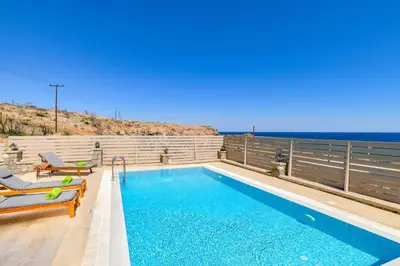 a swimming pool with a view of the ocean at Villa Kiotari by Villa Plus in Kiotari