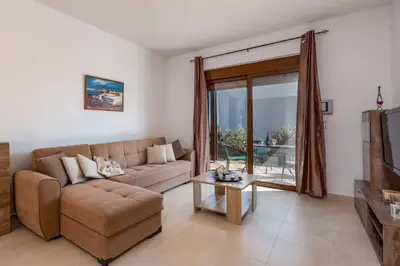 a living room with a couch and a table at Villa Kiotari by Villa Plus in Kiotari