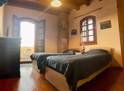 two beds in a room with a window at VILLA VICTORIA OLD TOWN in Rhodes Town