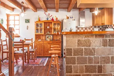 a kitchen with a counter and a table and chairs at VILLA VICTORIA OLD TOWN in Rhodes Town