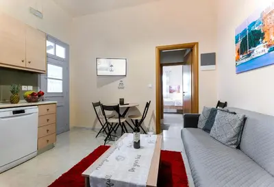 a living room with a couch and a table at Eddy's Apartment in Rhodes Town
