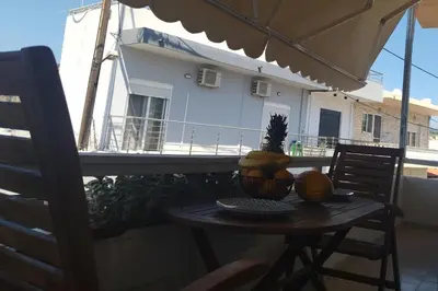 a table with a bowl of fruit on a balcony at Piazza Masari in Haraki