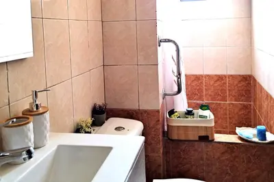 a bathroom with a toilet and a sink and a tub at Piazza Masari in Haraki