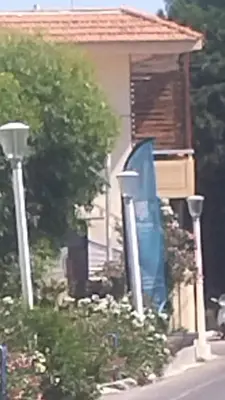a house with a bluearp on the front of it at Piazza Masari in Haraki