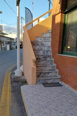 a set of stairs next to a brick building at Piazza Masari in Haraki