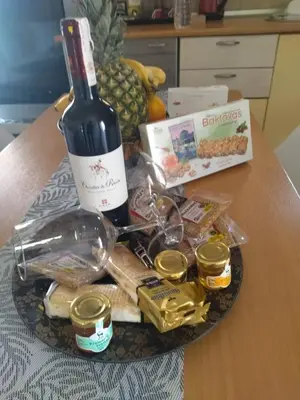 a plate with a bottle of wine and food on a table at Piazza Masari in Haraki