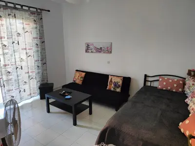a living room with a bed and a coffee table at Hibiscus Green Apartments in Afantou