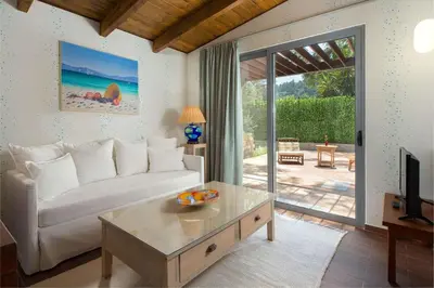a living room with a white couch and a table at Dionysos Hotel in Ixia