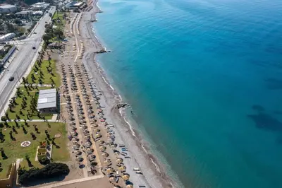 an aerial view of a beach with a bunch of cars at Dionysos Hotel in Ixia