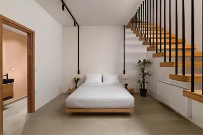 a bedroom with a bed and a staircase at Rhodes Island View in Ixia