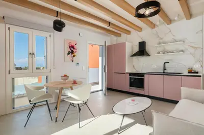 a kitchen and living room with a table and chairs at Rhodes Island View in Ixia
