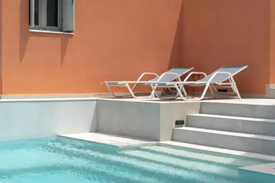 two chairs sitting next to a swimming pool at Rhodes Island View in Ixia