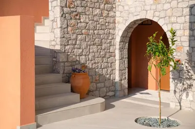 a plant in a vase next to a building at Rhodes Island View in Ixia
