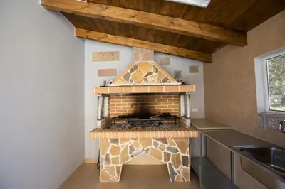 a kitchen with a brick oven in the corner at Serenity Sea-View Home in Afantou