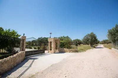 a dirt road with a gate and a fence at Serenity Sea-View Home in Afantou