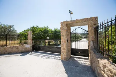 an entrance to a gate with an iron fence at Serenity Sea-View Home in Afantou