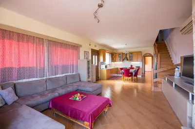 a living room with a couch and a table at Serenity Sea-View Home in Afantou