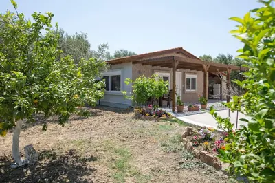 a house with a garden in front of it at Serenity Studio Beach Home in Afantou