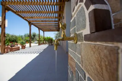a wall with a water hose attached to a building at Serenity Studio Beach Home in Afantou