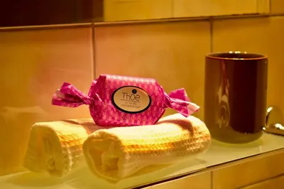 a pink tissue box sitting on a towel next to a mug at Carmen Art Hotel in Rhodes Town