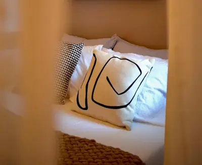 a white pillow sitting on a bed with at Carmen Art Hotel in Rhodes Town