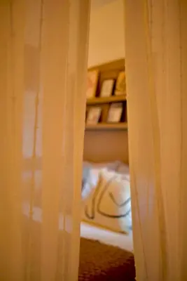 a view of a room with a bed and a shelf at Carmen Art Hotel in Rhodes Town