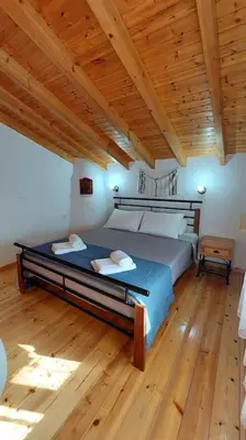 a bedroom with a bed and a wooden ceiling at Aleyna house Lindos area in Líndos
